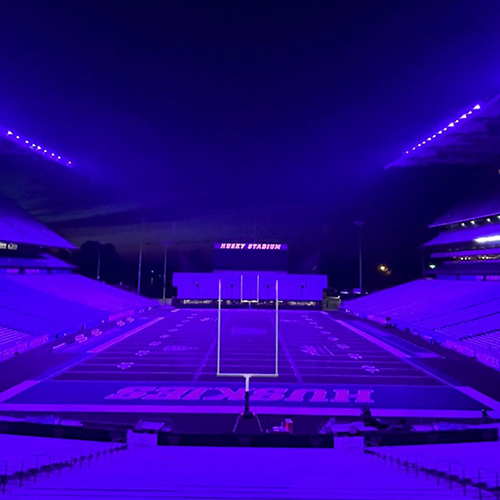 Husky Stadium bathed in purple light